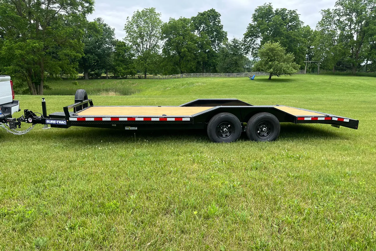 An empty trailer resting on the grass